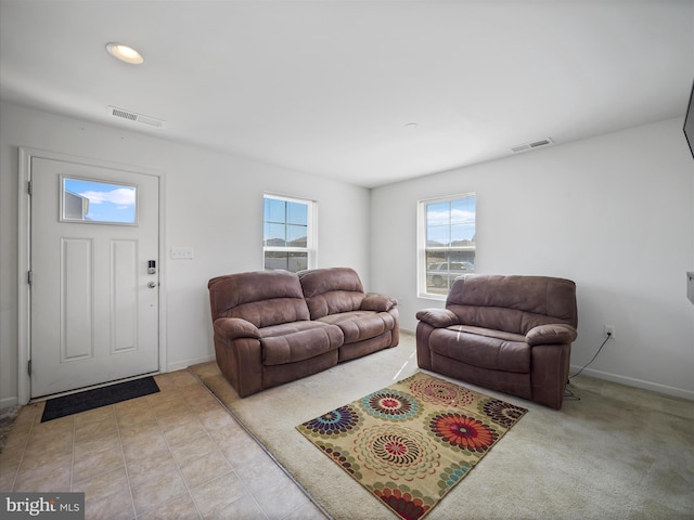 living area with baseboards and visible vents