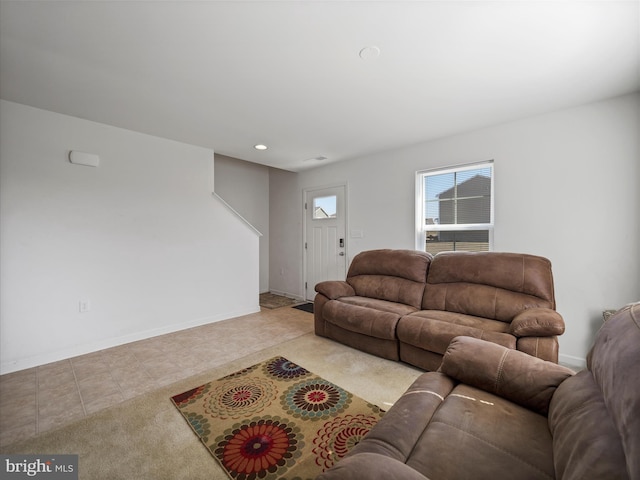 tiled living area with recessed lighting and baseboards