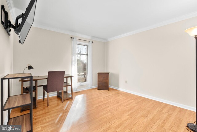 office area with baseboards, wood finished floors, and ornamental molding