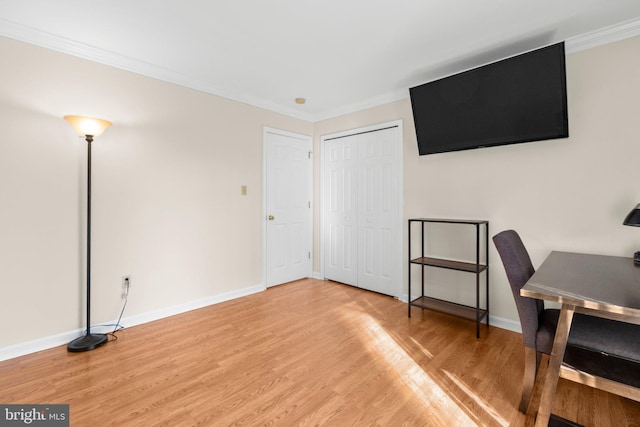 office space featuring baseboards, wood finished floors, and crown molding