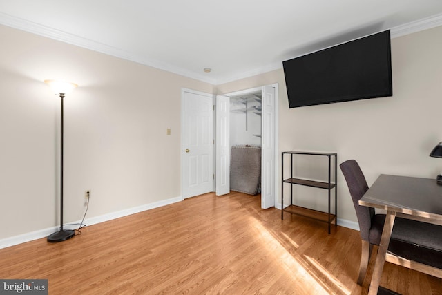 office with light wood finished floors, baseboards, and ornamental molding