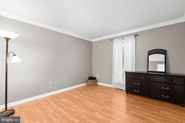 unfurnished bedroom with light wood-type flooring, baseboards, and ornamental molding