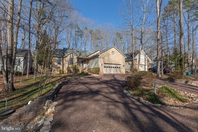 view of front of home featuring aphalt driveway and a garage