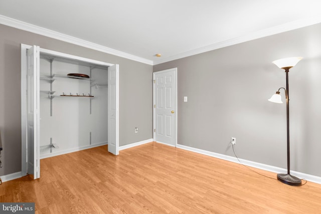 unfurnished bedroom featuring a closet, baseboards, light wood finished floors, and ornamental molding