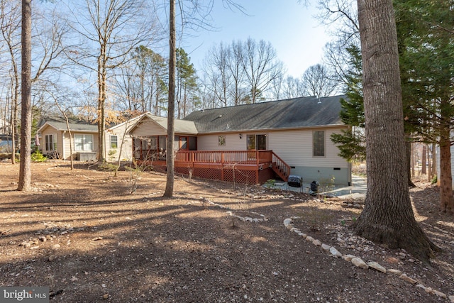 rear view of house with crawl space and a deck