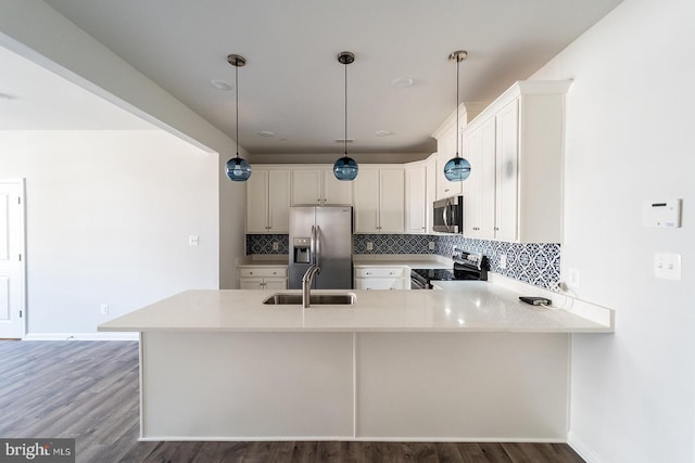 kitchen with a sink, decorative backsplash, appliances with stainless steel finishes, and light countertops