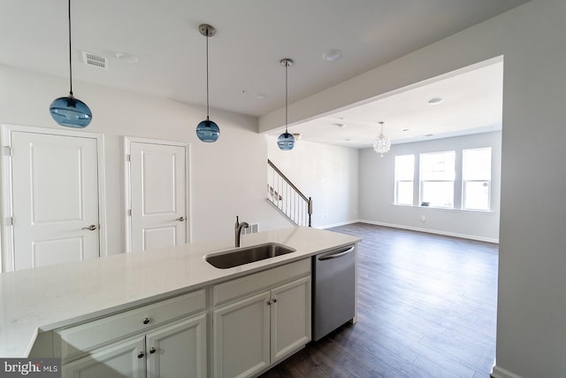 kitchen with decorative light fixtures, dishwasher, dark wood-type flooring, and a sink