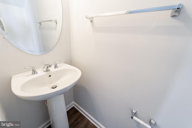 bathroom with wood finished floors and baseboards