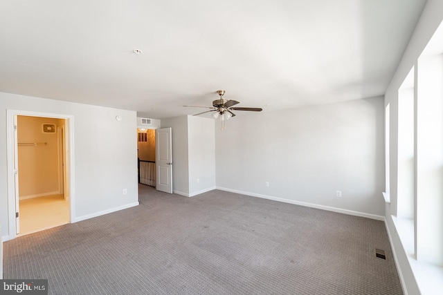 unfurnished room with a ceiling fan, baseboards, visible vents, and carpet floors