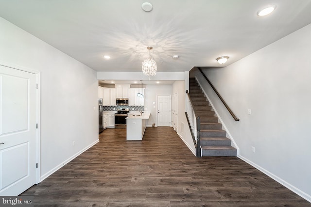 kitchen featuring dark wood-style floors, decorative backsplash, light countertops, white cabinets, and appliances with stainless steel finishes