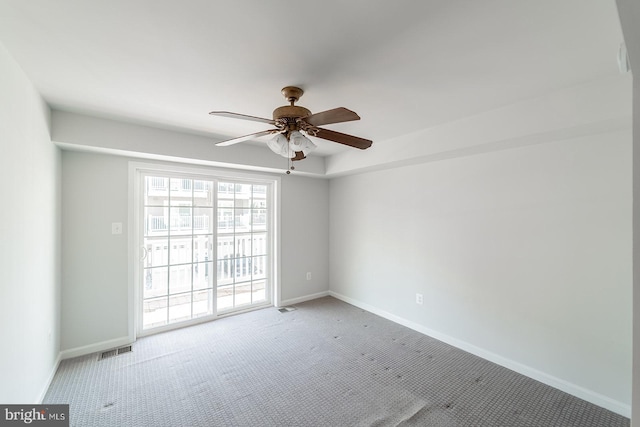 unfurnished room featuring visible vents, baseboards, a ceiling fan, and carpet flooring