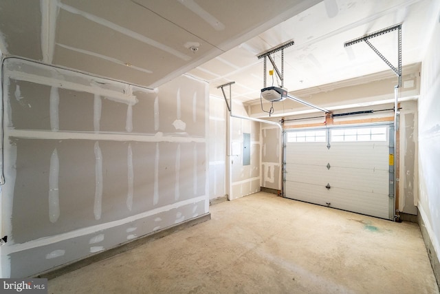 garage with electric panel and a garage door opener