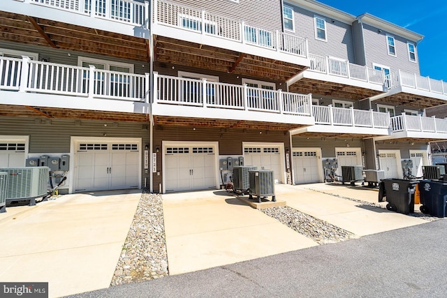 exterior space featuring a garage, driveway, and central AC