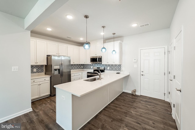 kitchen featuring dark wood finished floors, visible vents, appliances with stainless steel finishes, and a peninsula