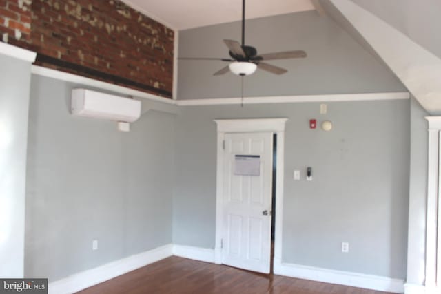 unfurnished room with a ceiling fan, wood finished floors, baseboards, and a wall mounted AC