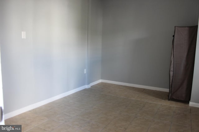 spare room with baseboards