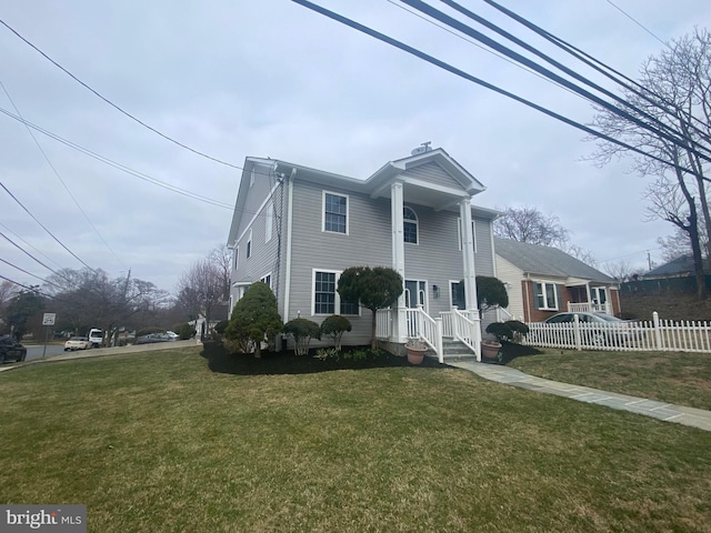 neoclassical / greek revival house with a front yard and fence