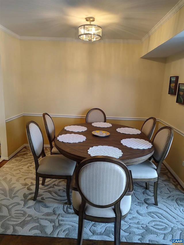 dining space with baseboards and ornamental molding