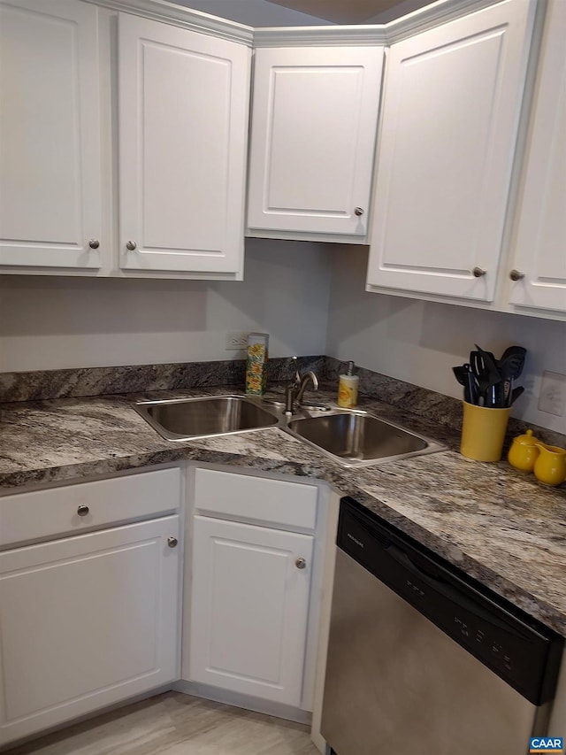 kitchen featuring white cabinets, dishwasher, light wood-type flooring, and a sink