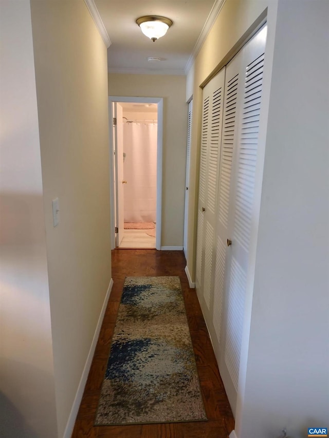 hallway featuring crown molding and baseboards