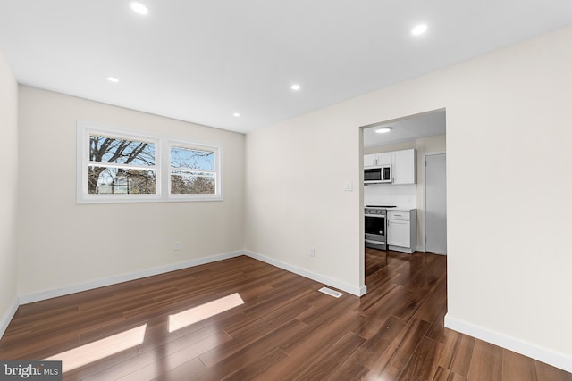 interior space with dark wood-style floors, recessed lighting, and baseboards