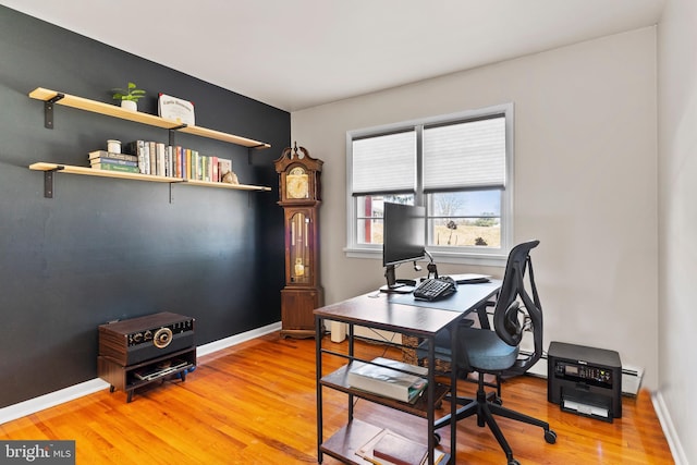 office with baseboards, light wood-style floors, and a baseboard radiator