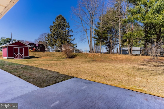 view of yard with a storage shed and an outdoor structure