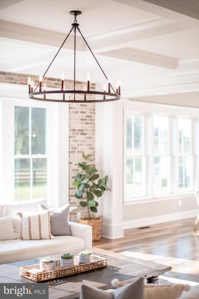 unfurnished sunroom featuring beam ceiling and a chandelier