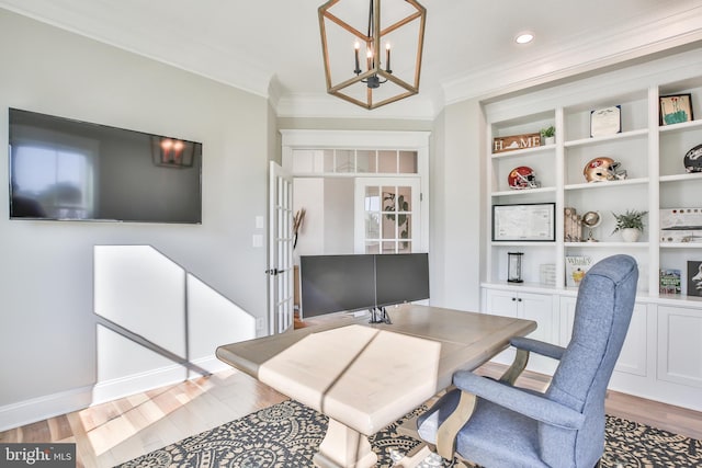 office area with baseboards, ornamental molding, recessed lighting, wood finished floors, and a notable chandelier