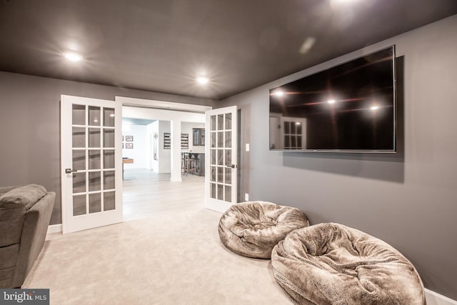 living area with recessed lighting, french doors, and carpet flooring