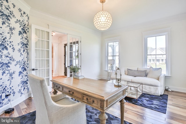 office area with wood finished floors, baseboards, and ornamental molding