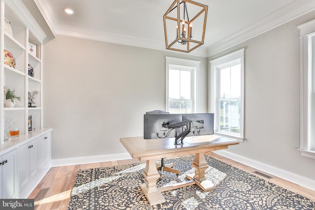 office area with visible vents, crown molding, light wood finished floors, baseboards, and a chandelier