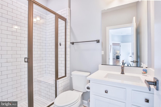 full bathroom with toilet, a stall shower, and vanity