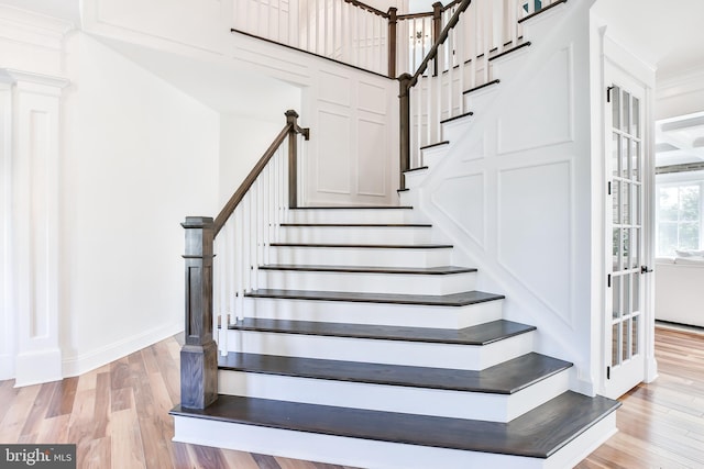 stairway featuring wood finished floors and baseboards