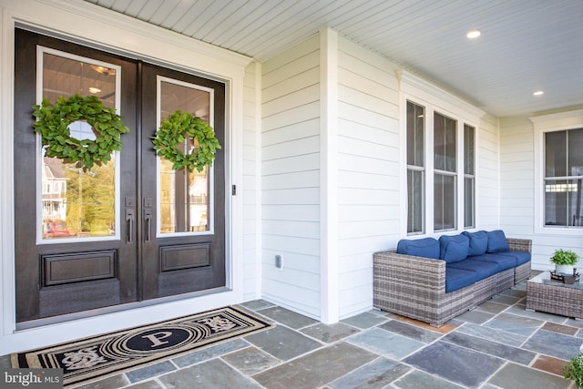 property entrance with an outdoor living space and french doors