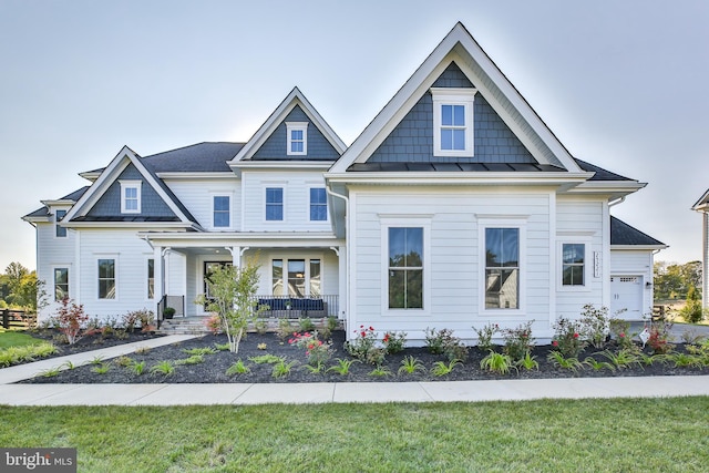 view of front of home featuring covered porch and a standing seam roof