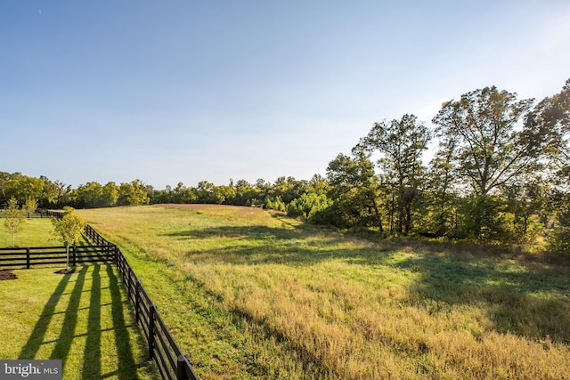 view of yard with a rural view and fence