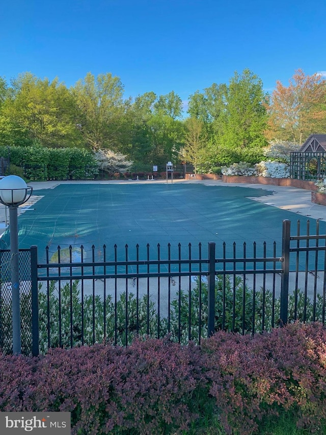 view of pool featuring fence