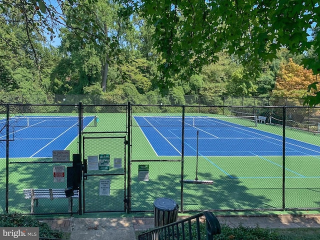 view of sport court featuring a gate and fence