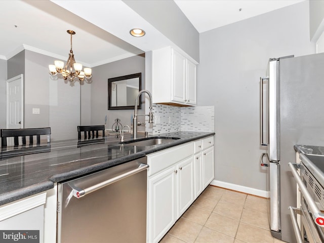 kitchen featuring light tile patterned flooring, a sink, white cabinets, appliances with stainless steel finishes, and tasteful backsplash