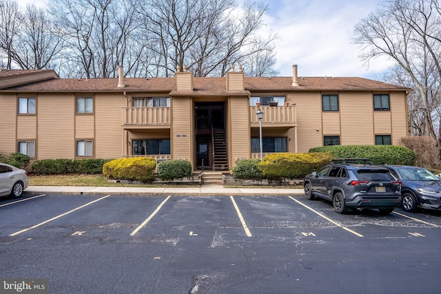 view of building exterior with uncovered parking