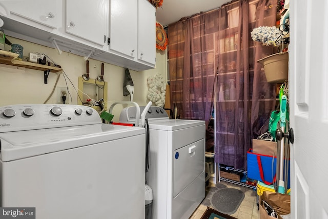 laundry area with washer and clothes dryer and cabinet space