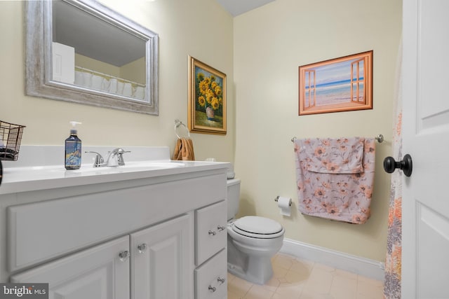 bathroom with tile patterned floors, toilet, vanity, and baseboards