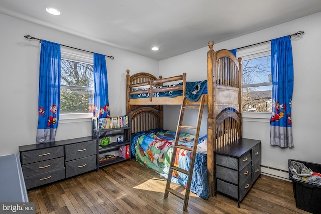 bedroom with recessed lighting, a baseboard radiator, and dark wood-type flooring