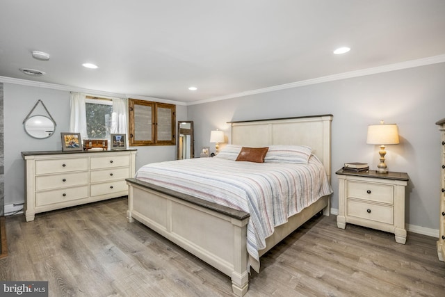 bedroom with ornamental molding, wood finished floors, and a baseboard radiator