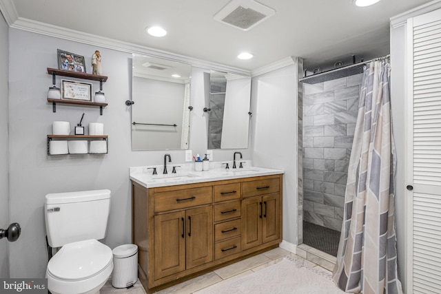 bathroom featuring visible vents, tiled shower, and a sink