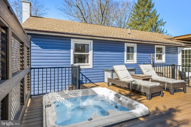 deck featuring hot tub deck surround