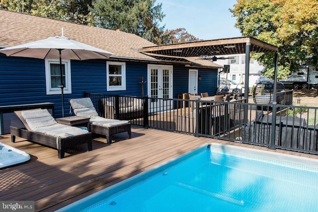 view of pool featuring french doors and a deck