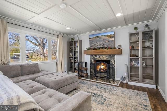 living room featuring a high end fireplace, baseboards, wood ceiling, ornamental molding, and wood finished floors