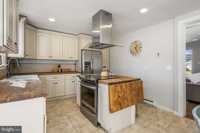 kitchen with wooden counters, island exhaust hood, a sink, stainless steel appliances, and baseboard heating